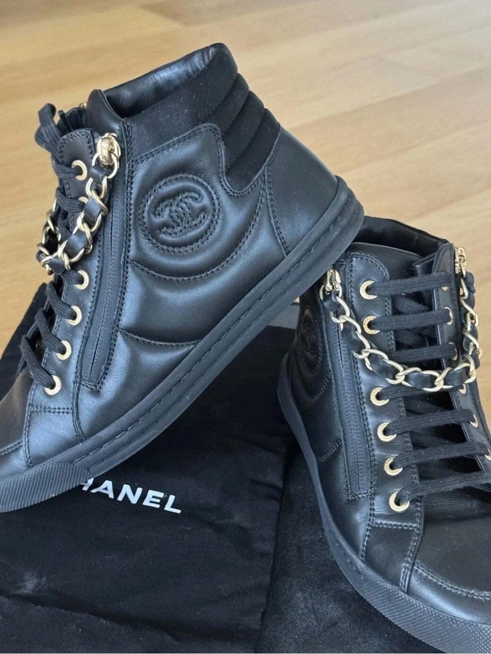 CHANEL Black Quilted High-Top Leather Sneakers with Gold Hardware